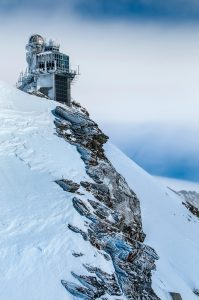 Exterior of a snow research institute with scientists observing snow and avalanche conditions in the mountains.