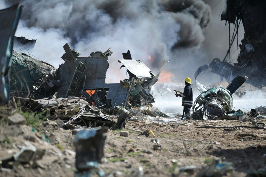 Rescue teams examining debris in a remote area