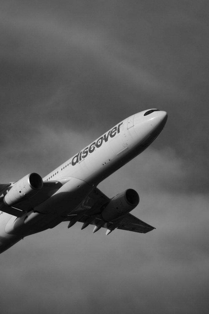 Airbus A330 flying amid dark storm clouds over the ocean