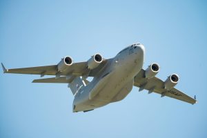 US Air Force Boeing C-17 plane close in clear skies viewed from below