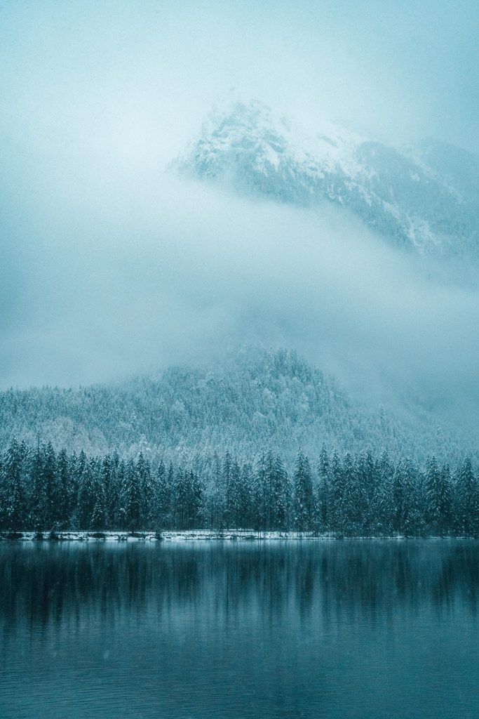 Mountain, forest, and lake covered in fog in Ramsau bei Berchtesgaden, BY, Germany